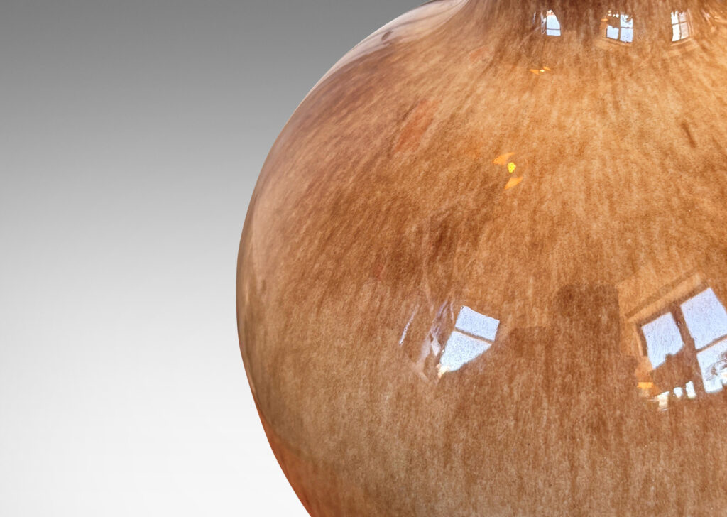 Gallery BAC globe form glazed in a beachy flowing dappled brown