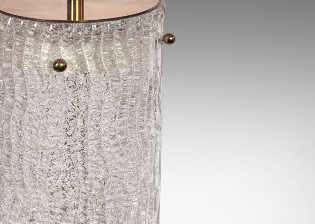 Gallery BAC cylindrical form comprised of glass panels with a wavy relief texture mounted to a brass frame and cap