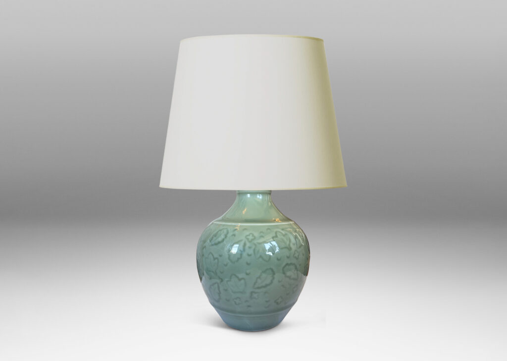 Gallery BAC apered globe form with coved neck, with carved floating leaf motifs, glazed in a thick ethereal celadon green