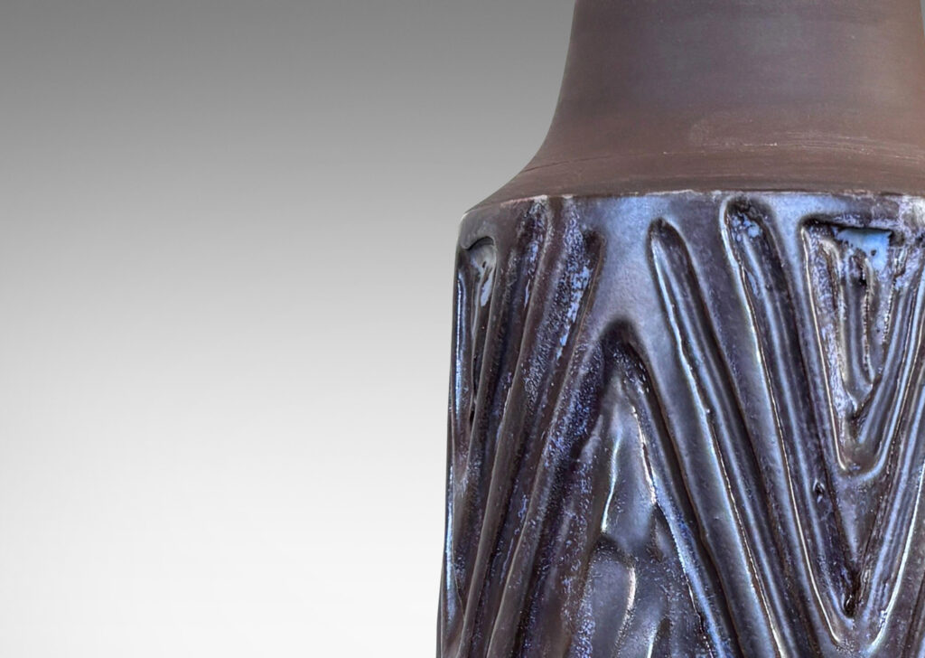 Gallery BAC conical form with robust carved lozenge patterning, glazed in eggshell finish dark purple and matte brown