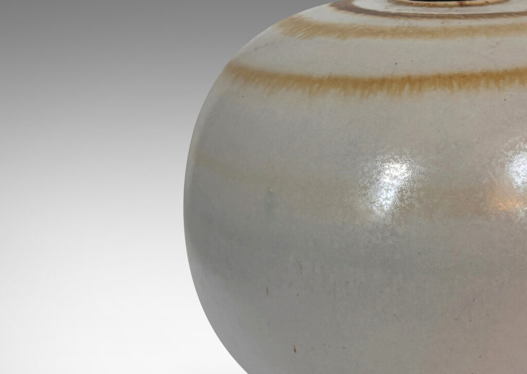 Gallery BAC plump globe form with small mouth, glazed in an eggshell finish pale gray with watery concentric circles in light brown