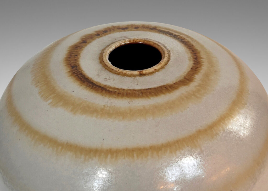 Gallery BAC plump globe form with small mouth, glazed in an eggshell finish pale gray with watery concentric circles in light brown