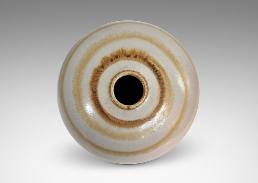 Gallery BAC plump globe form with small mouth, glazed in an eggshell finish pale gray with watery concentric circles in light brown