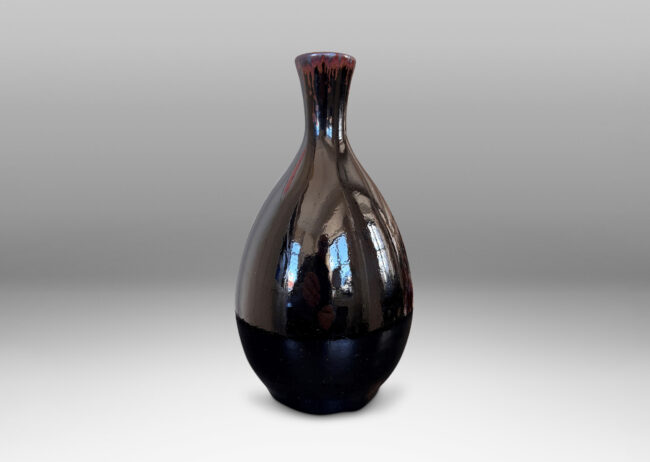 Gallery BAC sleek ovoid body and flared neck, glazed in a glossy brown with red luster accent to mouth