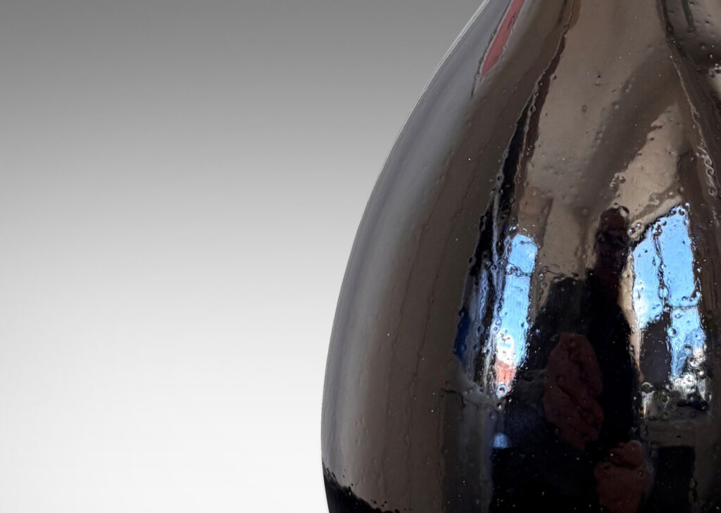 Gallery BAC sleek ovoid body and flared neck, glazed in a glossy brown with red luster accent to mouth