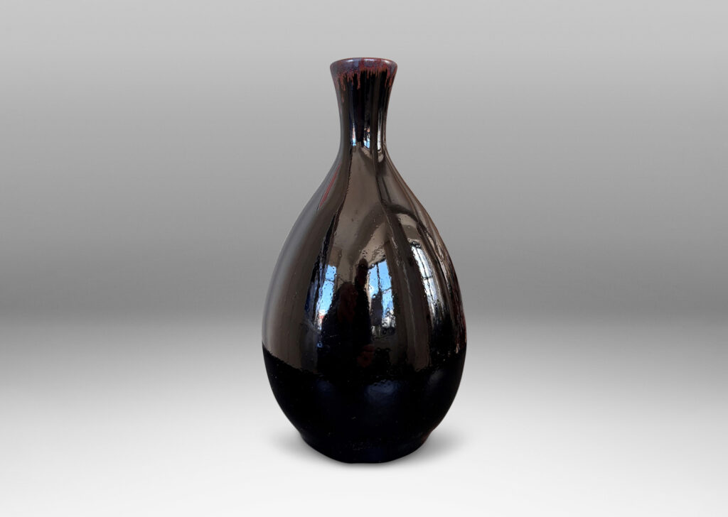 Gallery BAC sleek ovoid body and flared neck, glazed in a glossy brown with red luster accent to mouth