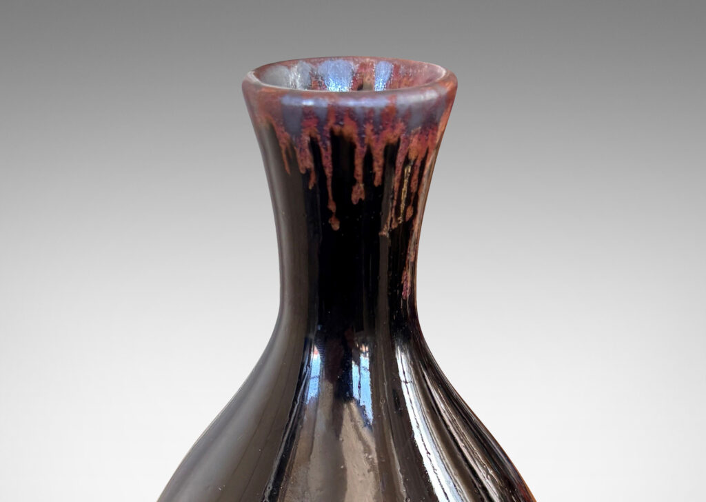 Gallery BAC sleek ovoid body and flared neck, glazed in a glossy brown with red luster accent to mouth