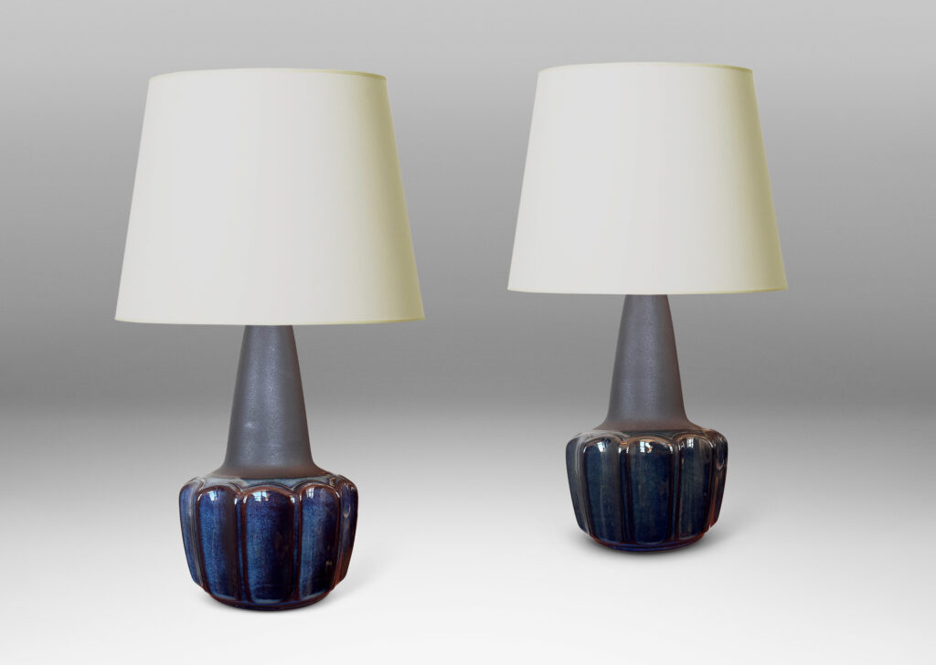 Gallery BAC pawn-like forms with a fluted drum body and conical neck, glazed in a gloss blue luster and matte brown