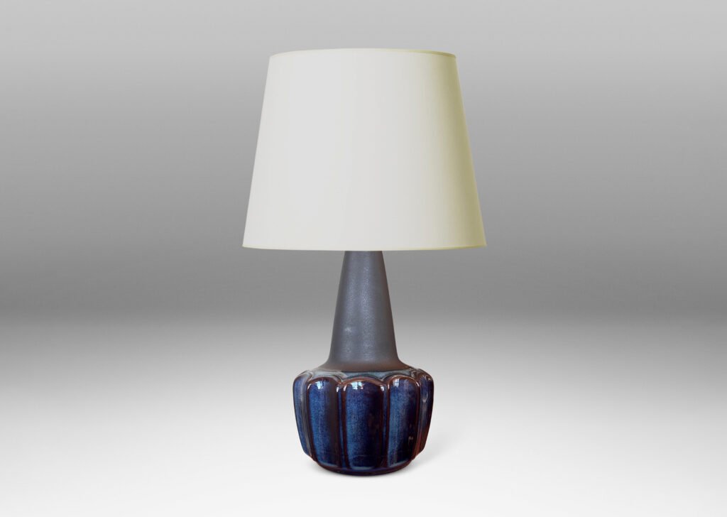 Gallery BAC pawn-like forms with a fluted drum body and conical neck, glazed in a gloss blue luster and matte brown