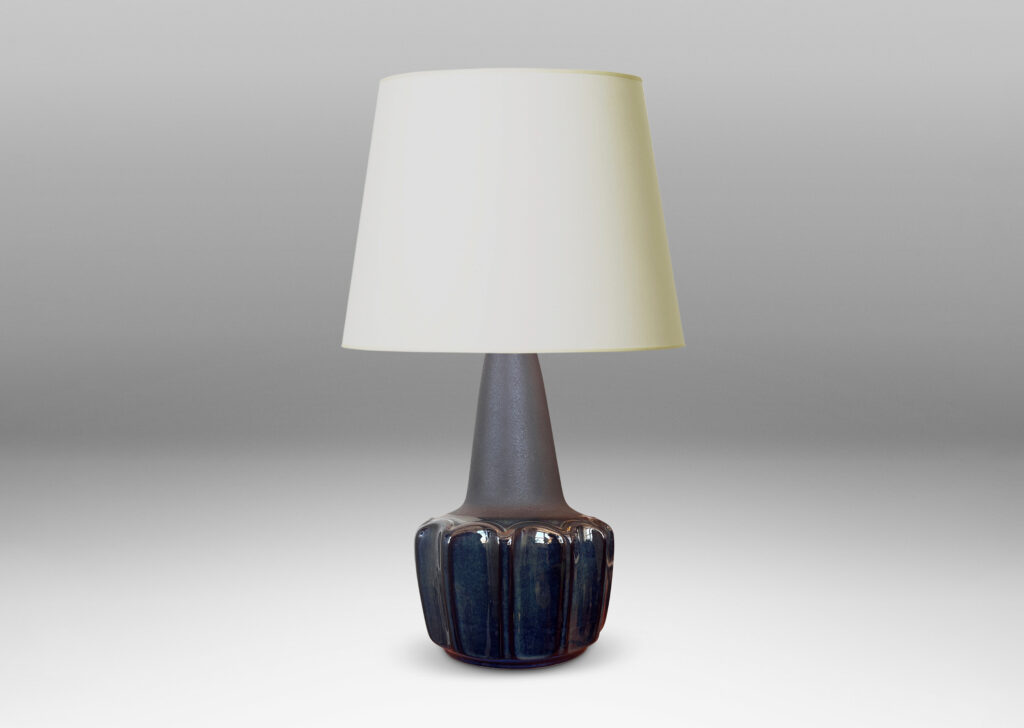 Gallery BAC pawn-like forms with a fluted drum body and conical neck, glazed in a gloss blue luster and matte brown