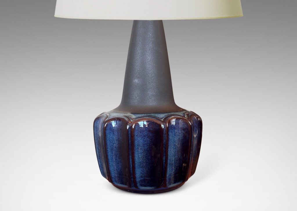 Gallery BAC pawn-like forms with a fluted drum body and conical neck, glazed in a gloss blue luster and matte brown