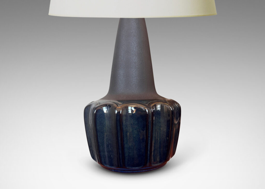Gallery BAC pawn-like forms with a fluted drum body and conical neck, glazed in a gloss blue luster and matte brown