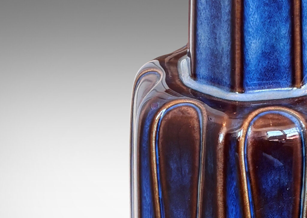 Gallery BAC tiered octagonal form with leaf-shaped panels, glazed in a luster blue with brown accents