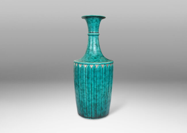 Gallery BAC tapered flited form with tall neck and flared mouth, glazed in a sponged copper oxide bluish green