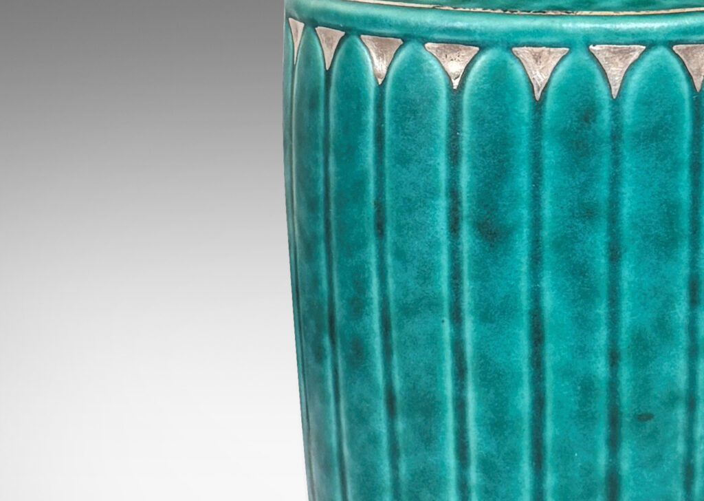 Gallery BAC tapered flited form with tall neck and flared mouth, glazed in a sponged copper oxide bluish green