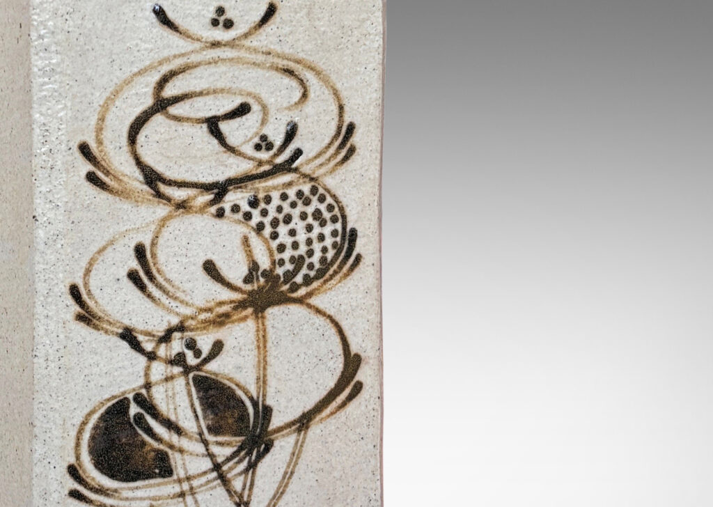 Gallery BAC square canister form with chamfered edges, glazed in pale gray, with horn-painted design in brown