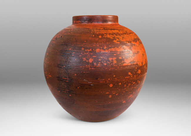 Gallery BAC globe form with carved pinstripe banding, glazed in matte orange and burnt orange brown
