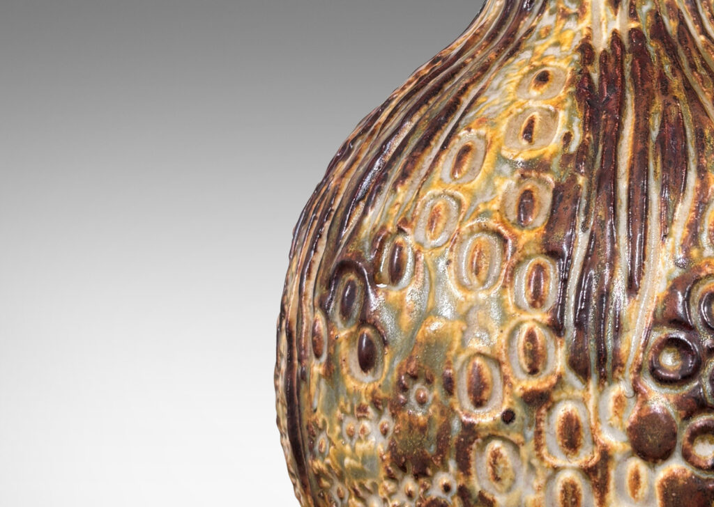 Gallery BAC bulbous form with organic reliefs evoking a seed pod, glazed in a pale taupe-brown
