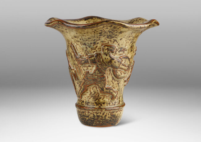 Gallery BAC onical form with undulating lip and relief mythological figures, with a masterful brown and light greige “Sung” glaze