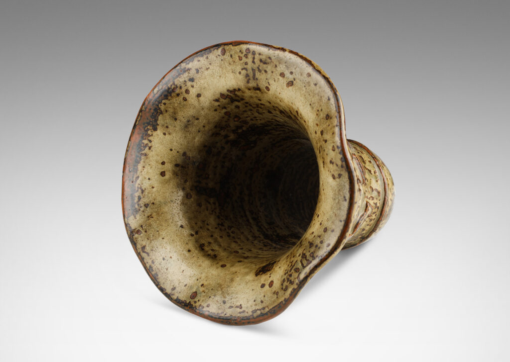Gallery BAC onical form with undulating lip and relief mythological figures, with a masterful brown and light greige “Sung” glaze