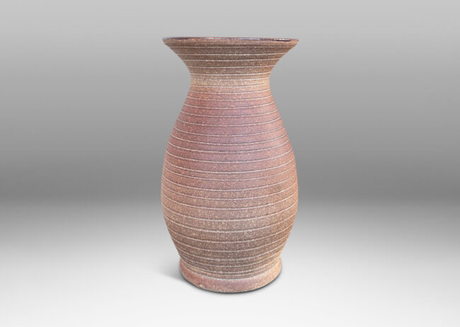 Gallery BAC tall swelling form with flared mouth and carved pinstripe spiral, partially glazed inside with an eggshell finish brown