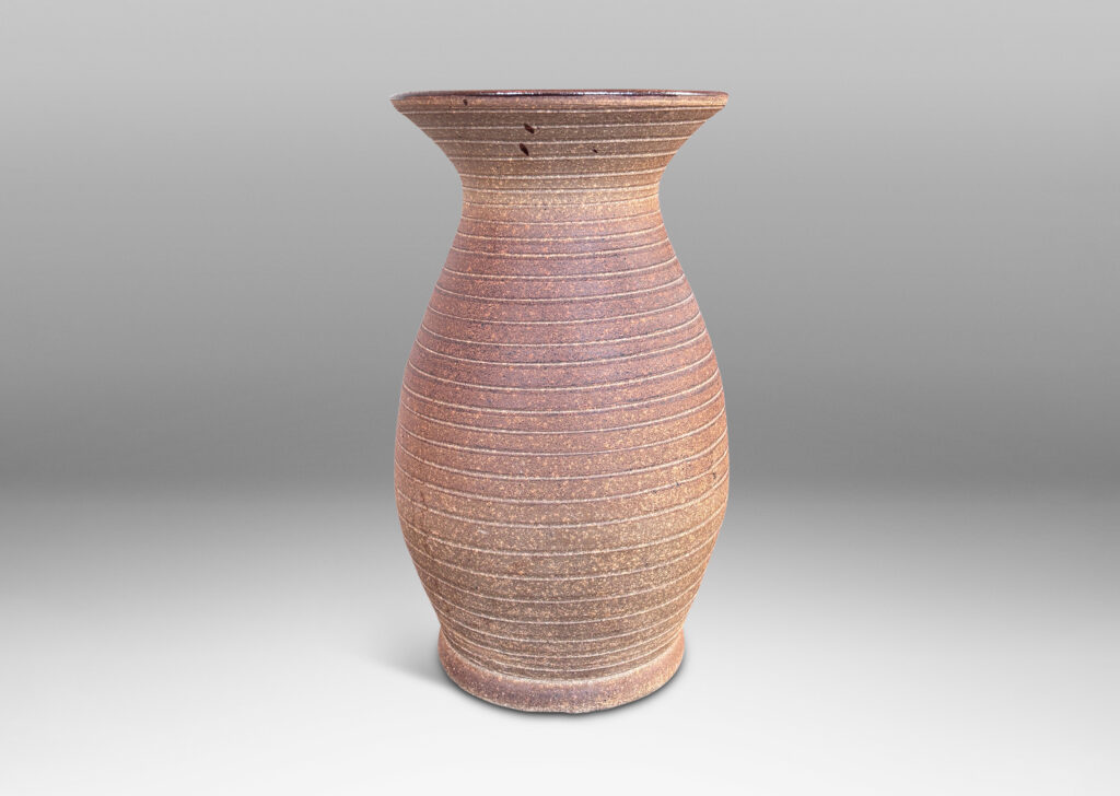 Gallery BAC tall swelling form with flared mouth and carved pinstripe spiral, partially glazed inside with an eggshell finish brown