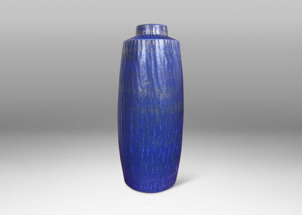 Gallery BAC swelling cylindrical form with carved gouged surface and flowing deep blue over brown glazing