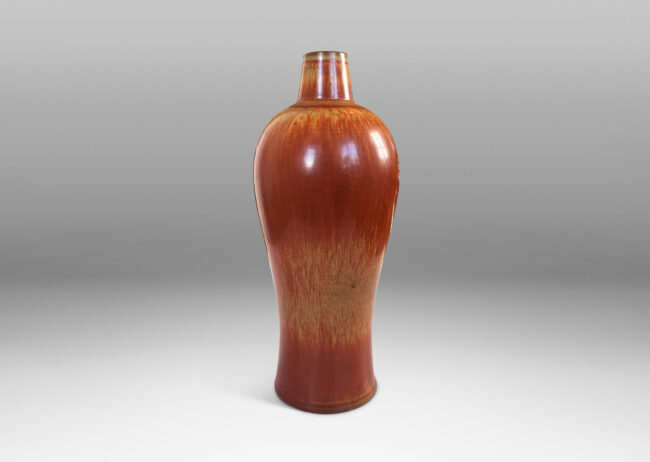 Gallery BAC sinuous form with swelling shoulders and a small conical neck, glazed in eggshell finish terra cotta orange and ochre