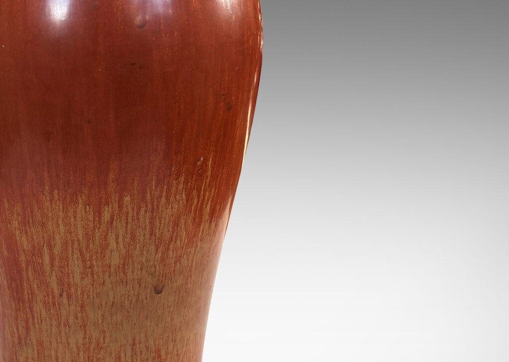 Gallery BAC sinuous form with swelling shoulders and a small conical neck, glazed in eggshell finish terra cotta orange and ochre