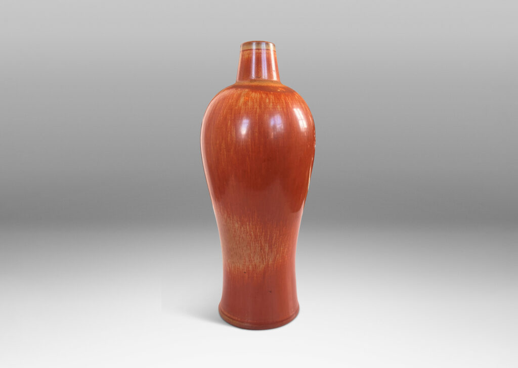 Gallery BAC sinuous form with swelling shoulders and a small conical neck, glazed in eggshell finish terra cotta orange and ochre