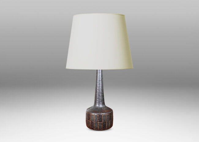 Gallery BAC low drum form with carved grid pattern, tall conical neck, and matte brown glaze