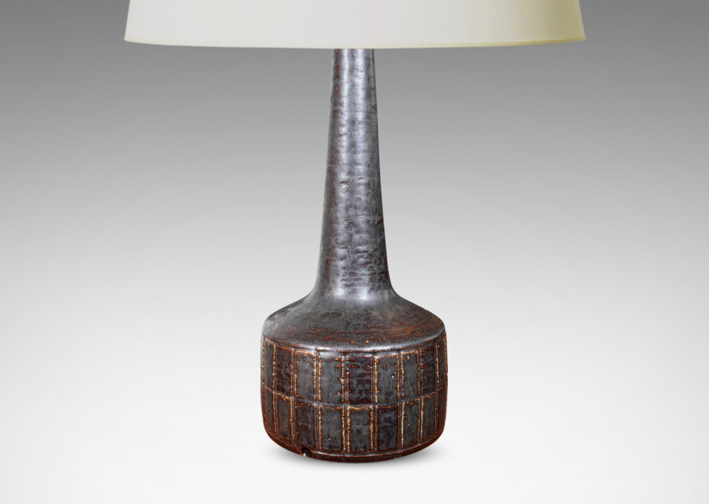 Gallery BAC low drum form with carved grid pattern, tall conical neck, and matte brown glaze