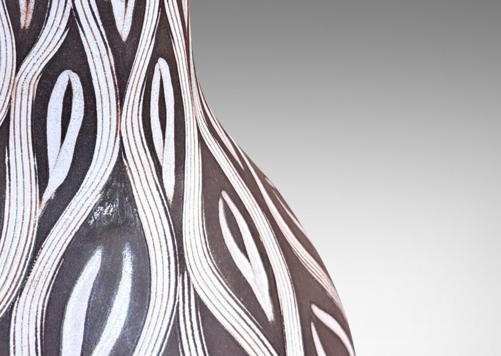 Gallery BAC gourd form with tall neck, glazed in matte brown with carved ogival pattern in semi-gloss white