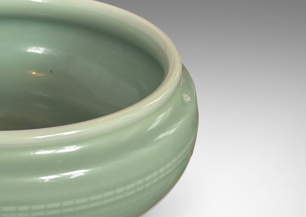 Gallery BAC wide form with sculpted sides, delicately flare lip and relief beaded banding, glazed in an ethereal celadon green