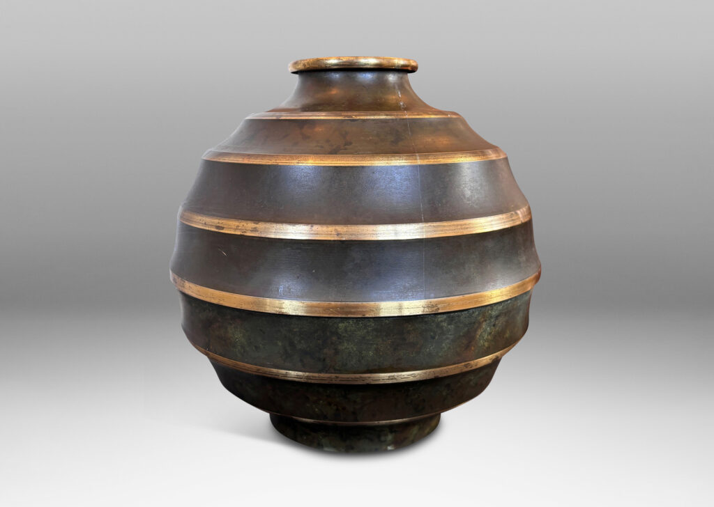 Gallery BAC globe form encircled in sharp lateral flutes, in bronze with verdigris patination and polished accents