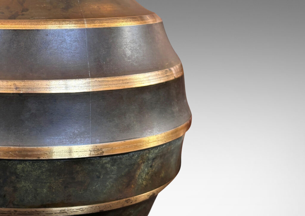 Gallery BAC globe form encircled in sharp lateral flutes, in bronze with verdigris patination and polished accents