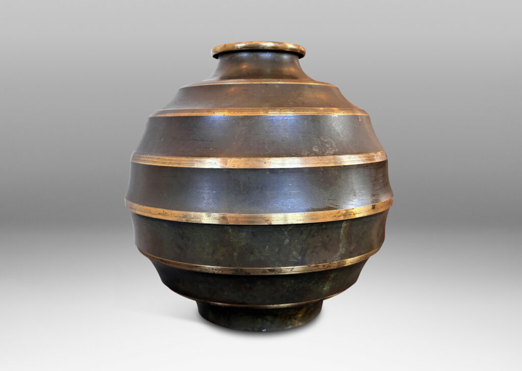 Gallery BAC globe form encircled in sharp lateral flutes, in bronze with verdigris patination and polished accents