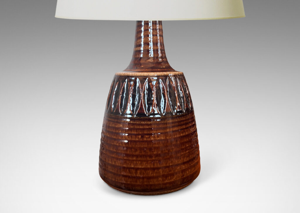Gallery BAC pawn-like form with ridged texture, band of carved ovoids, and sprouting neck, glazed in a glossy brown