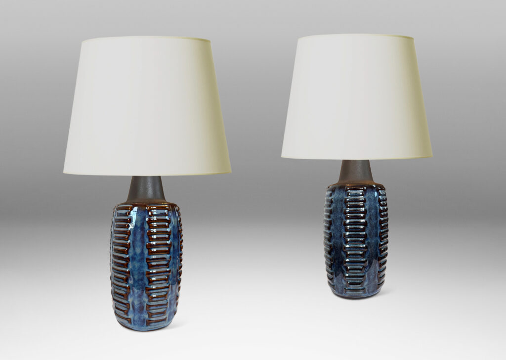 Gallery BAC swelling cylindrical forms ornamented with columns of relief bars, glazed in luster blue and matte brown