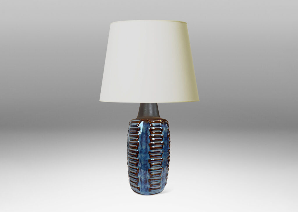 Gallery BAC swelling cylindrical forms ornamented with columns of relief bars, glazed in luster blue and matte brown