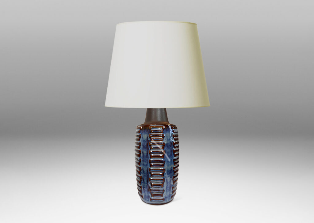 Gallery BAC swelling cylindrical forms ornamented with columns of relief bars, glazed in luster blue and matte brown