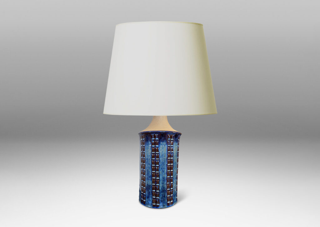 Gallery BAC cylindrical form with flared top, sprouting neck, and ornamented with columns of “I” motifs, partially glazed in a blue luster