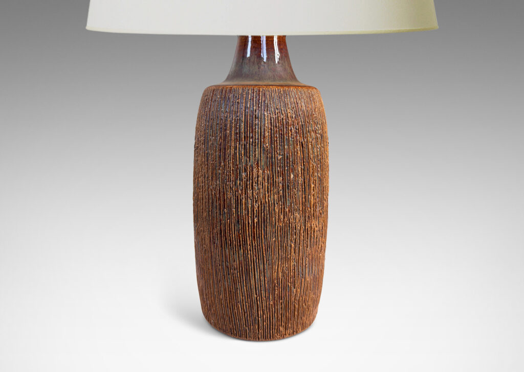 Gallery BAC swelling cylindrical form with a raked texture, glazed in a glossy brown-pale taupe