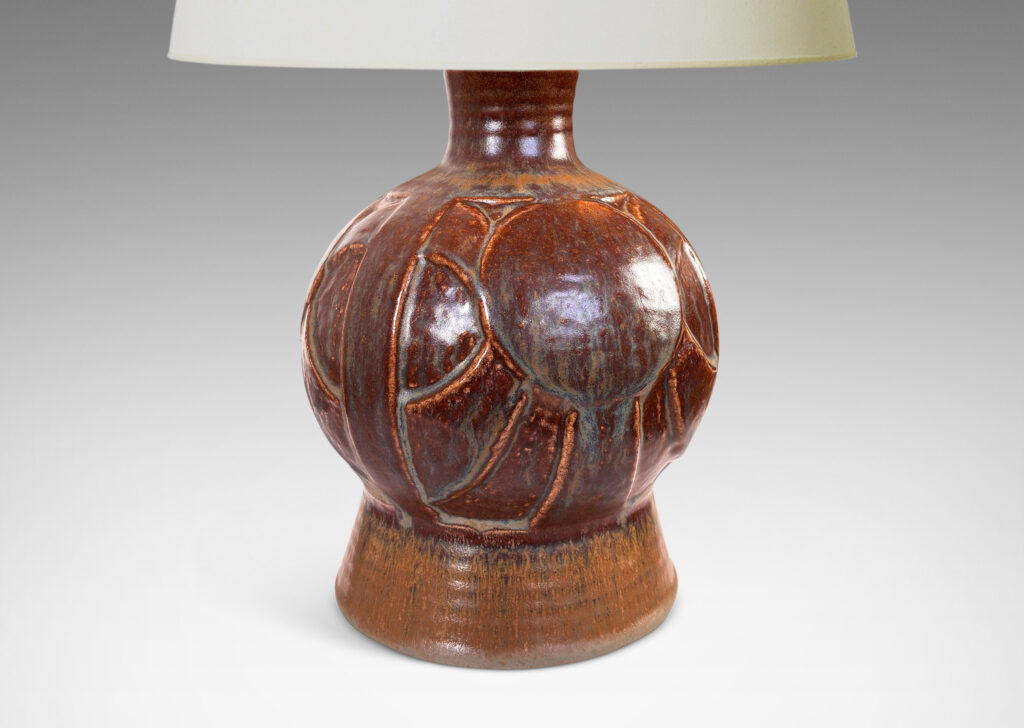 Gallery BAC globe form with geometric reliefs on a flanged foot, glazed in an eggshell finish brown-tan
