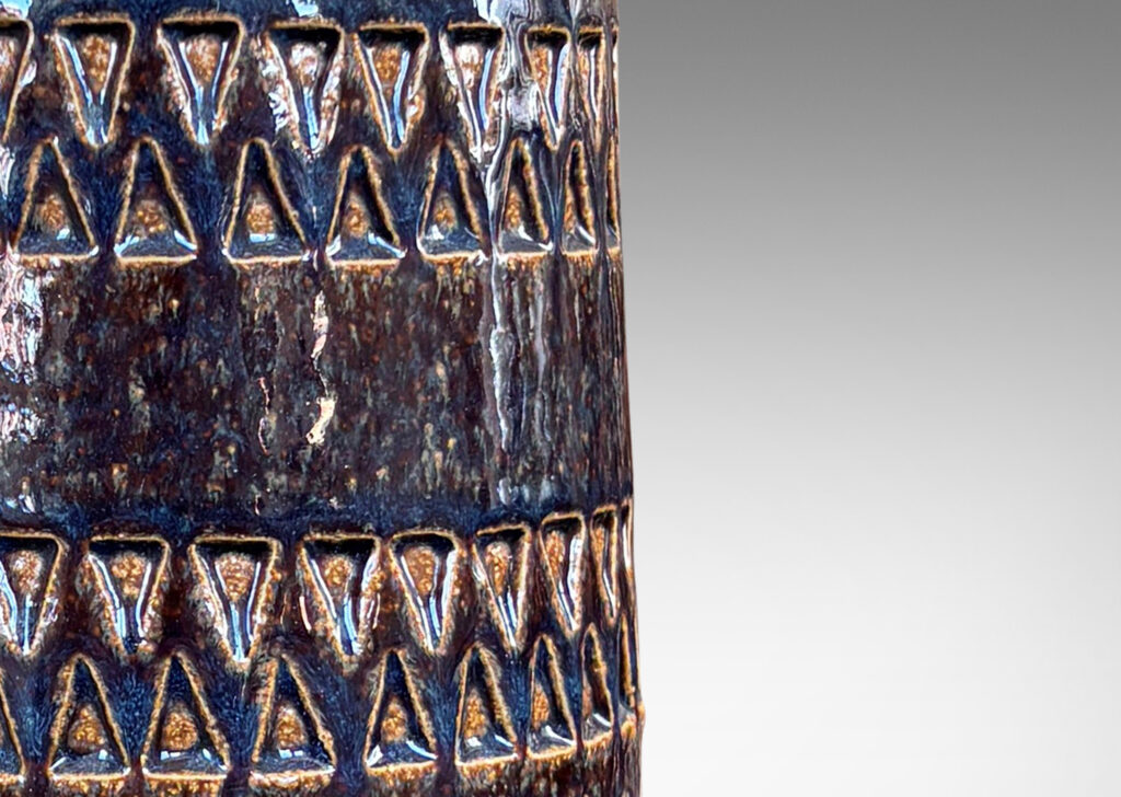 Gallery BAC welling cylindrical form with bands of impressed triangle motifs, partially glazed in glossy gray-blue