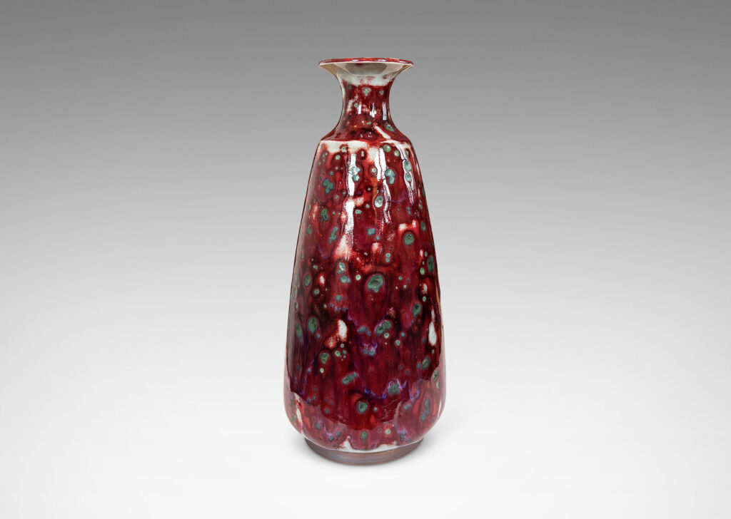 Gallery BAC tall swelling form with outstretched mouth, glazed in oxblood burgundy, with pale gray accents and green-gray dappling