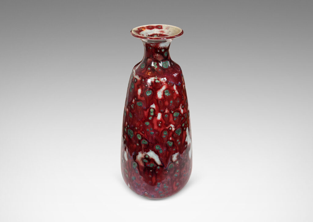 Gallery BAC tall swelling form with outstretched mouth, glazed in oxblood burgundy, with pale gray accents and green-gray dappling