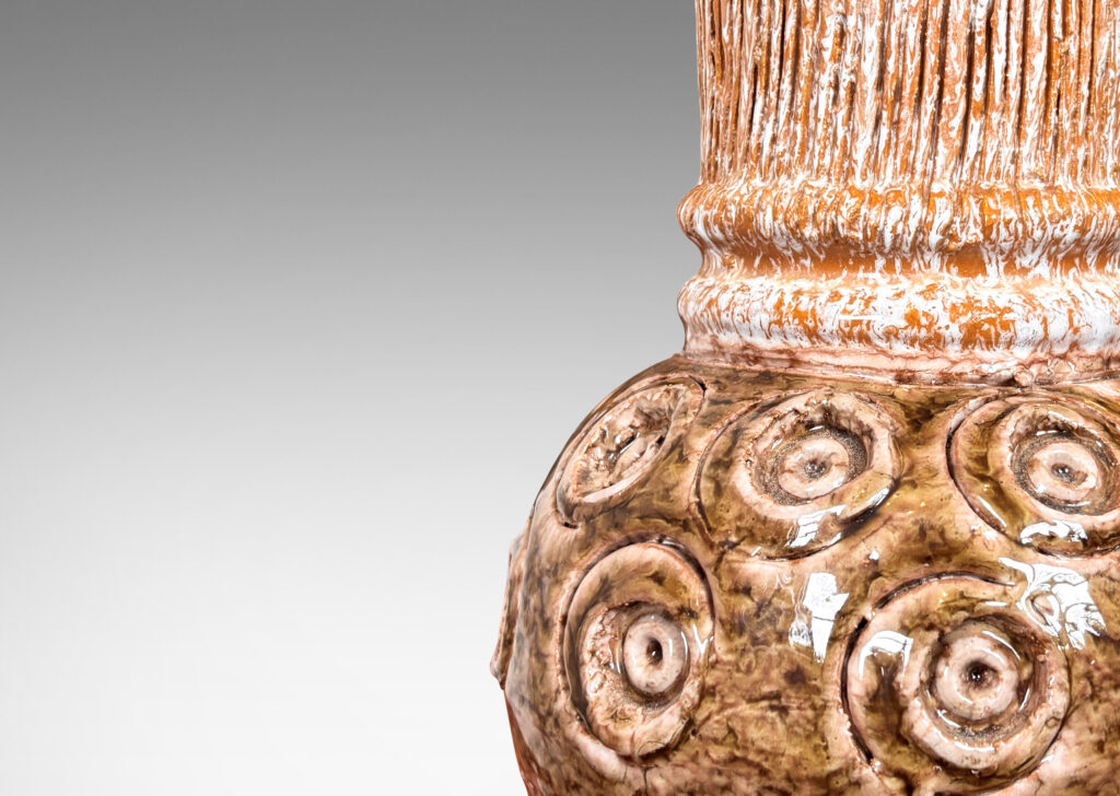 Gallery BAC globe forms with carved concentric circle motifs in shiny olive green glaze, and wide textured necks in partial white glaze