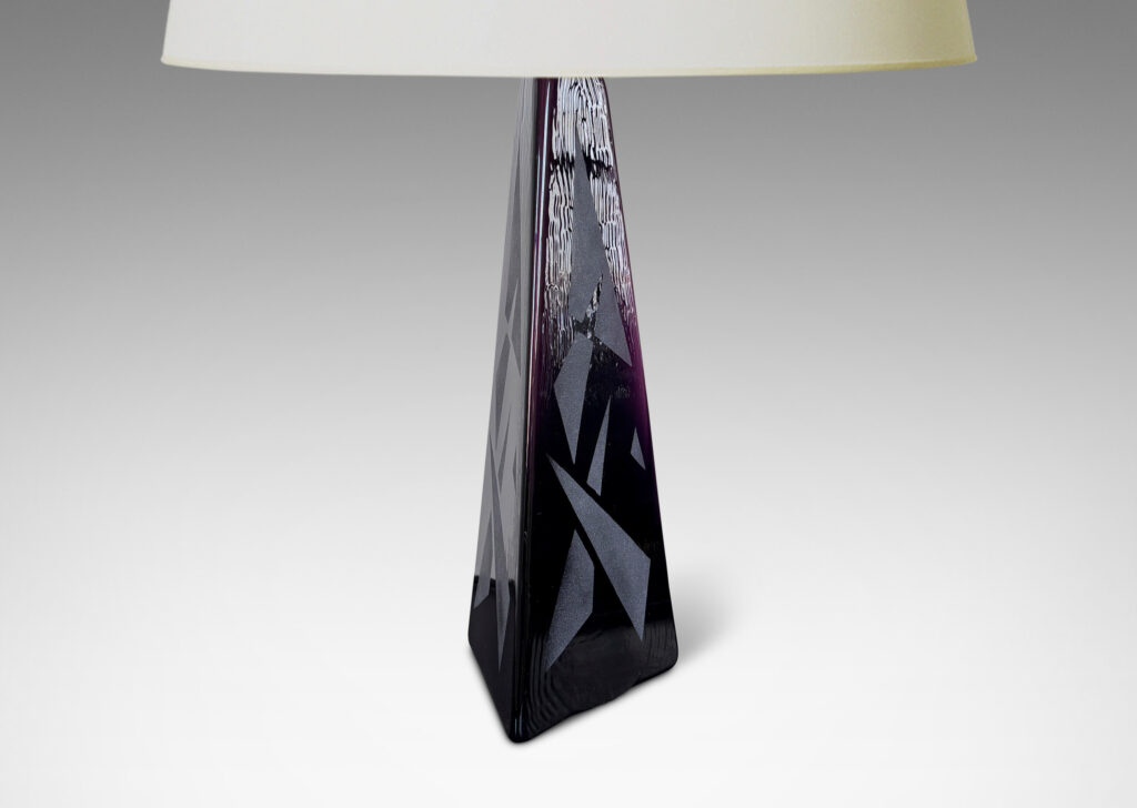 Gallery BAC tall triangular obelisk form in amethyst purple, with a polished finish ornamented with a sandblasted pattern of triangles