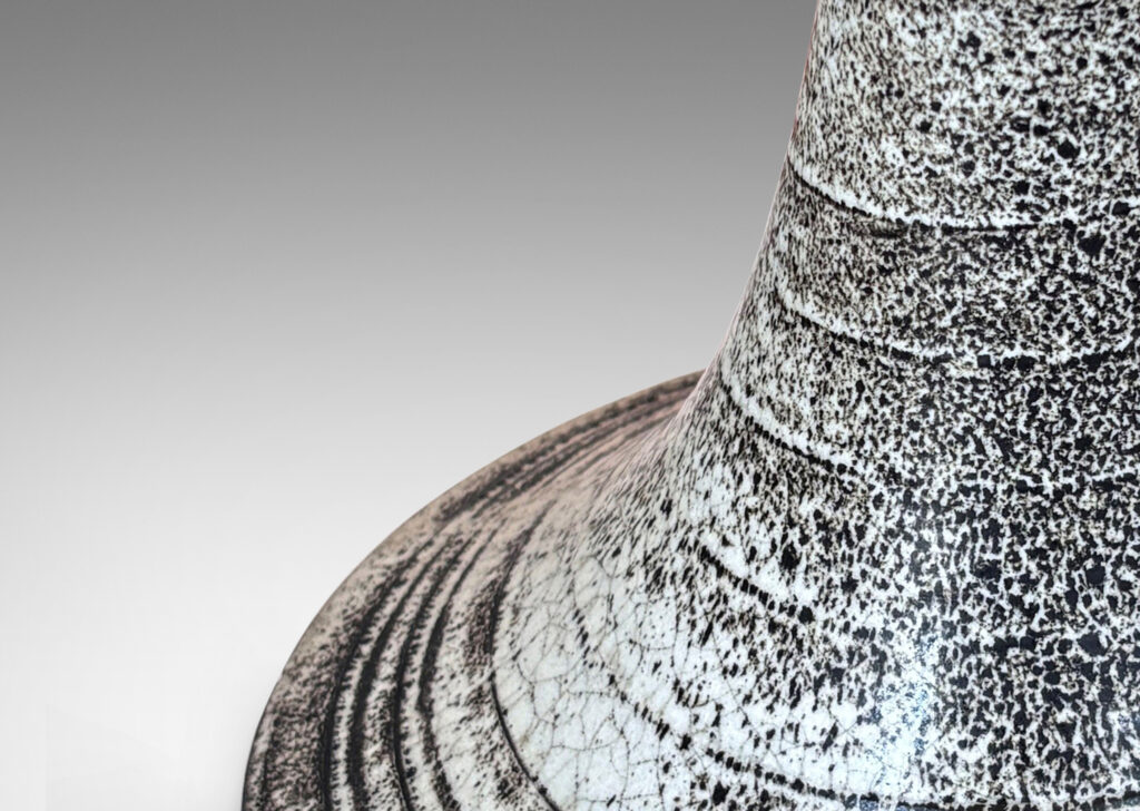 Gallery BAC flared trumpet form, with spiral ridging, glazed in white with black stippling